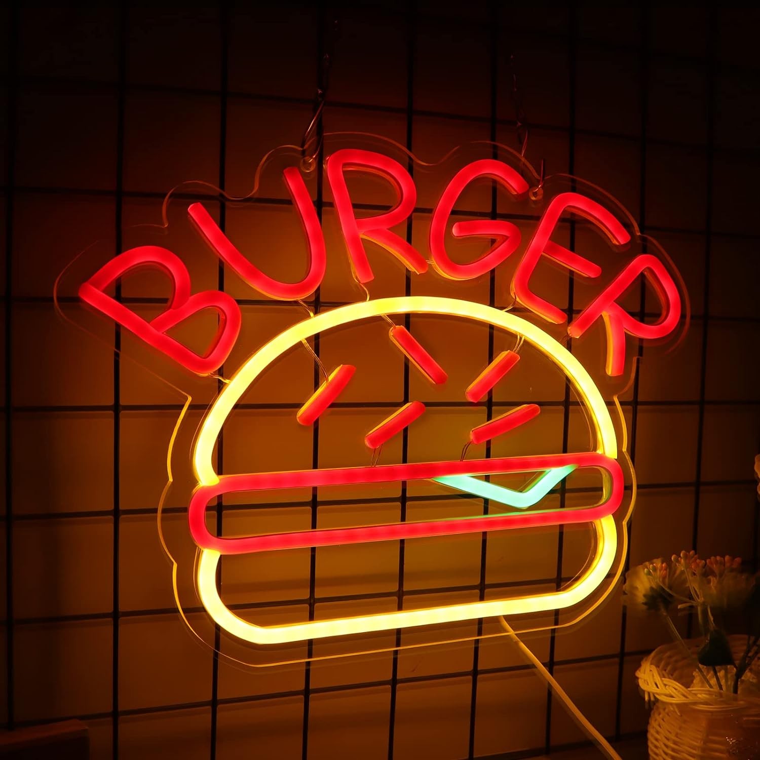 logo neonowego burgera oświetlającego burgera na ścianie